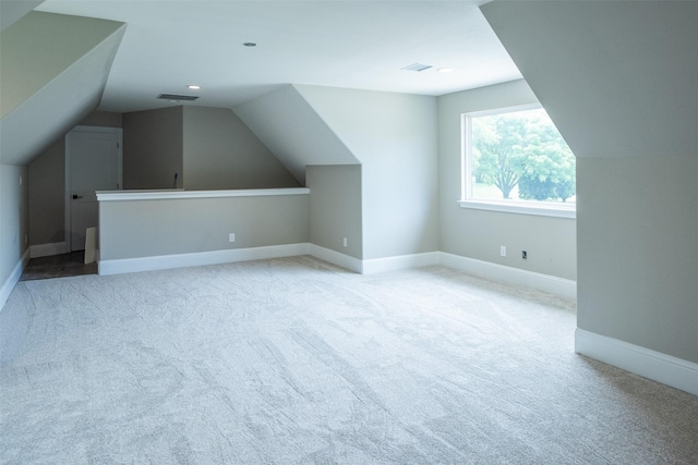 additional living space with lofted ceiling and light colored carpet