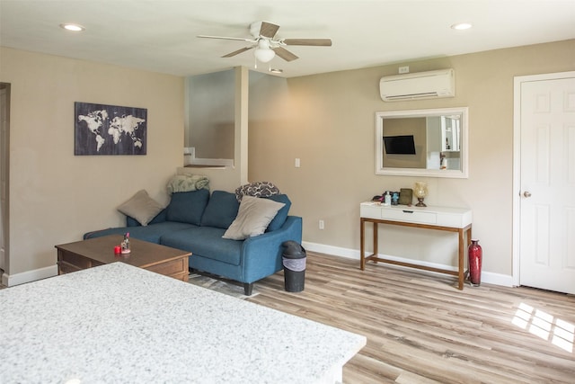 living room featuring hardwood / wood-style flooring, a wall mounted air conditioner, and ceiling fan