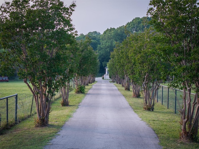 view of property's community featuring fence and a lawn