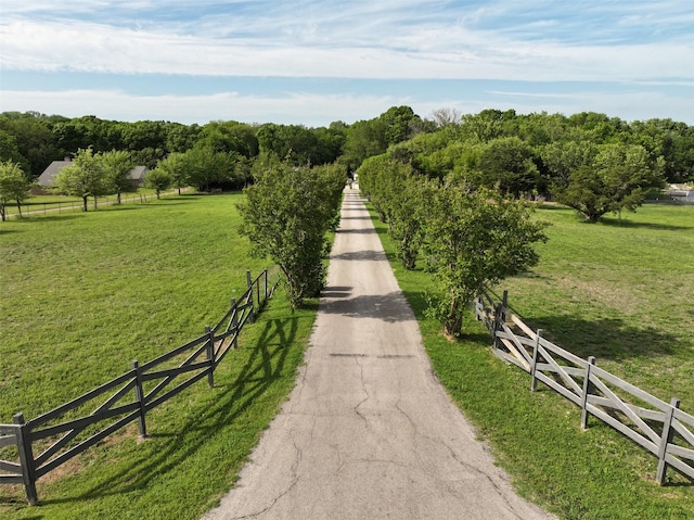 view of property's community featuring a yard and a rural view