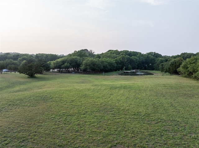 view of home's community featuring a rural view and a lawn