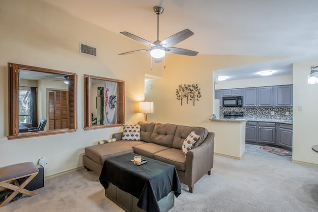 carpeted living room featuring high vaulted ceiling and ceiling fan