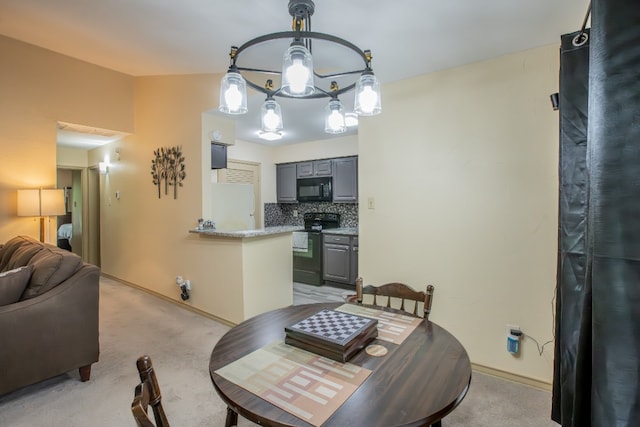 carpeted dining area with a chandelier