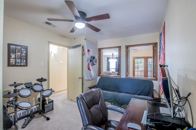 carpeted home office with ceiling fan