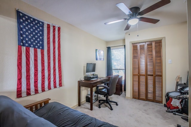 carpeted office with ceiling fan