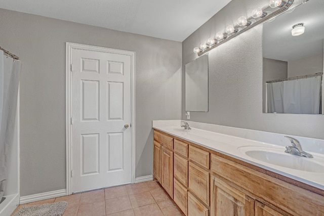 bathroom with tile floors and dual vanity