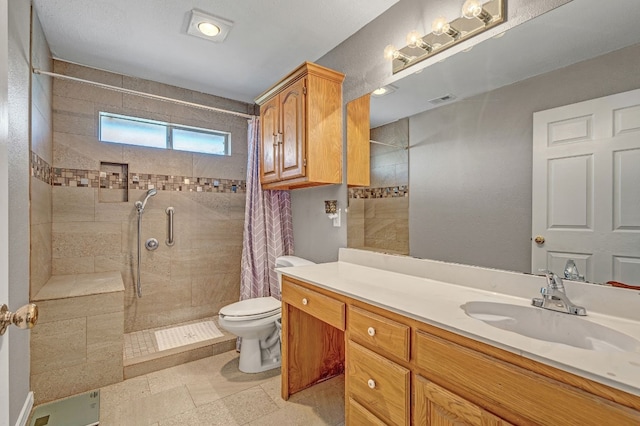 bathroom with tile flooring, vanity, toilet, and curtained shower