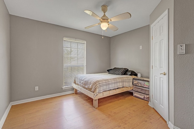 bedroom featuring light hardwood / wood-style flooring and ceiling fan