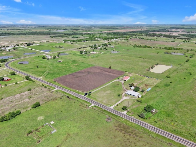 birds eye view of property with a rural view