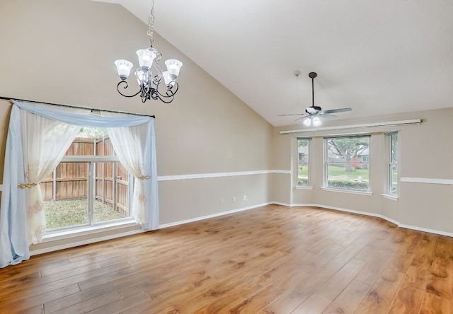 spare room with hardwood / wood-style flooring, a wealth of natural light, and vaulted ceiling