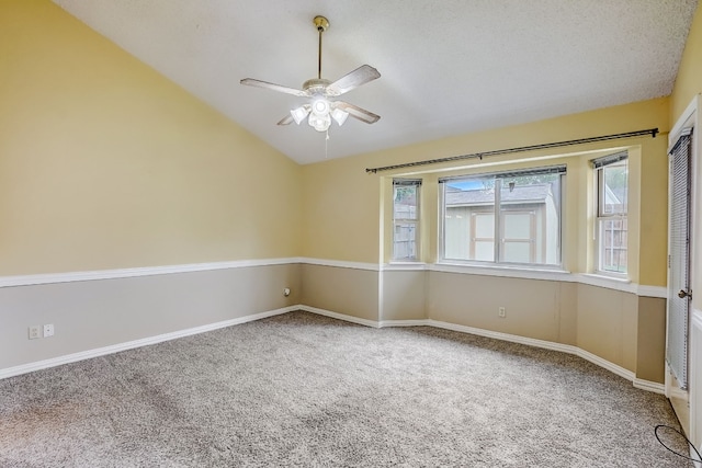 empty room with ceiling fan, carpet, and lofted ceiling