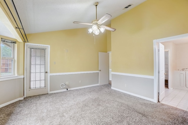 spare room featuring ceiling fan, high vaulted ceiling, and light colored carpet