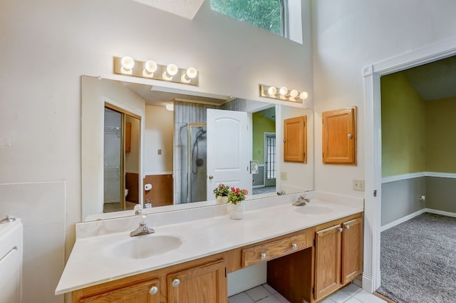 bathroom with tile patterned floors, vanity, and a shower with shower door