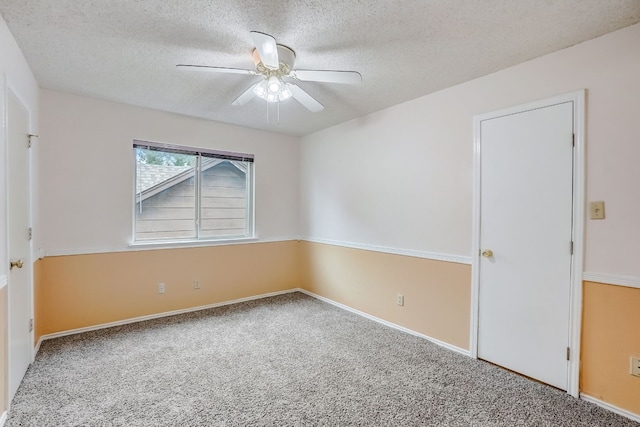 spare room with ceiling fan, carpet floors, and a textured ceiling