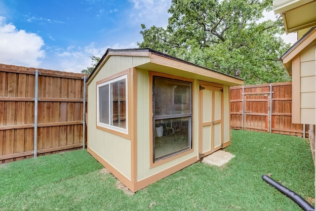 view of outbuilding with a yard