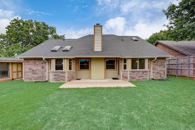 back of house with a yard and a patio