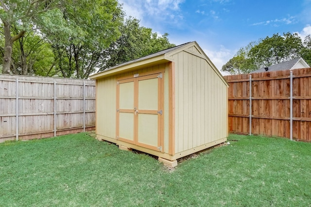 view of outbuilding with a yard