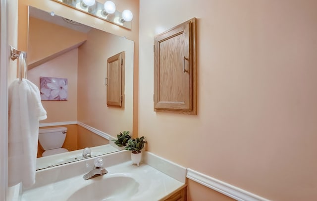 bathroom with vanity and toilet