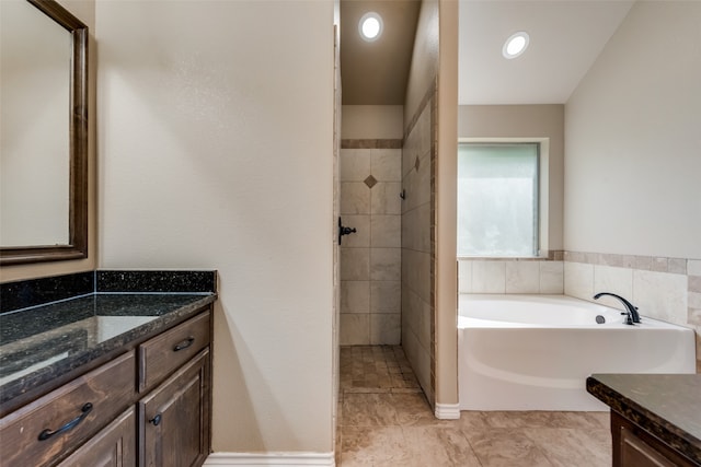 bathroom with shower with separate bathtub and vanity