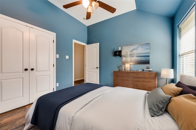 bedroom featuring lofted ceiling, ceiling fan, a closet, and hardwood / wood-style flooring