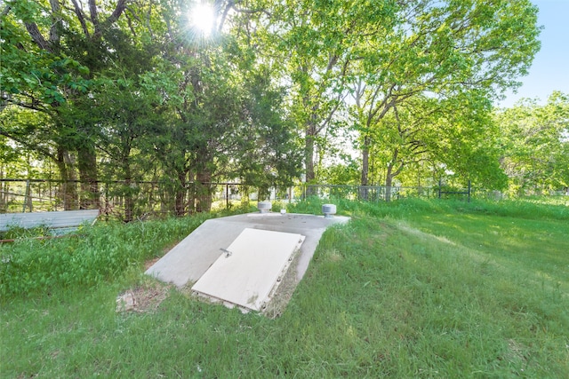 view of storm shelter with a lawn