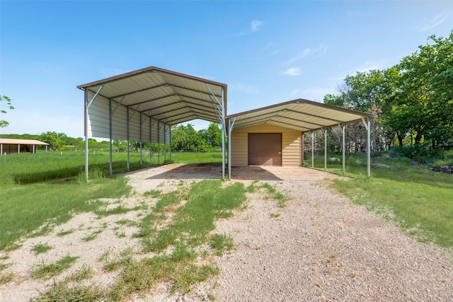 view of vehicle parking with a carport and a yard