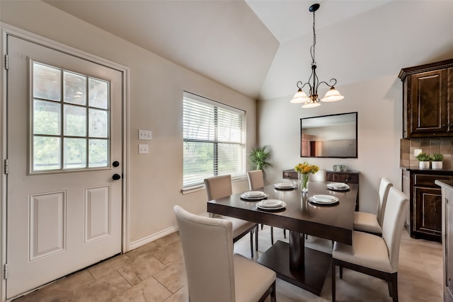 dining space featuring vaulted ceiling and a chandelier