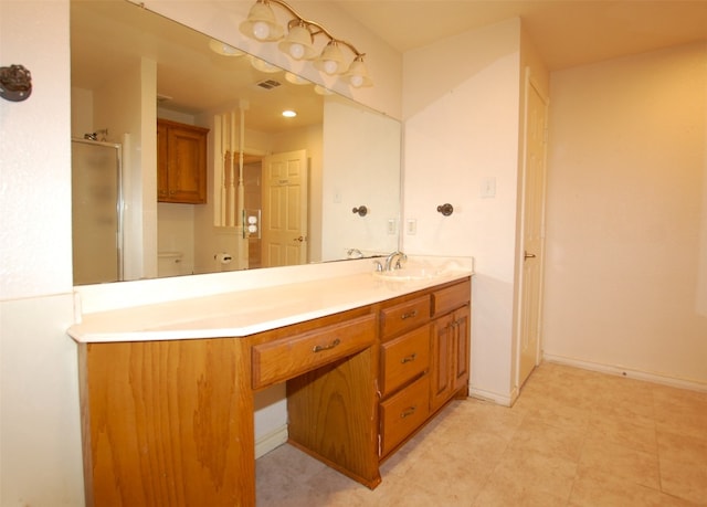 bathroom with an enclosed shower, vanity, and tile flooring