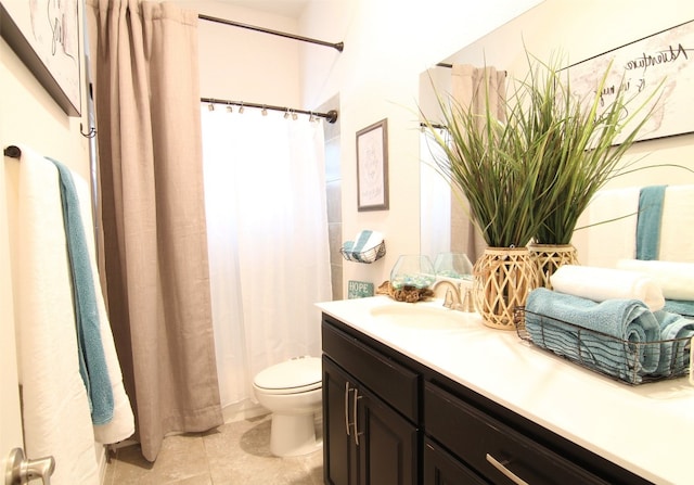 bathroom with tile floors, oversized vanity, and toilet