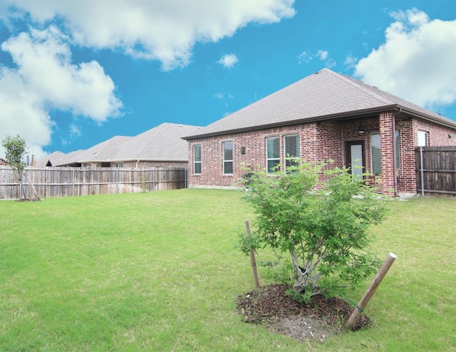 rear view of property with a lawn