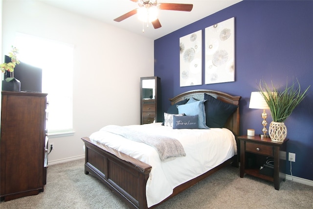 bedroom with ceiling fan and light carpet