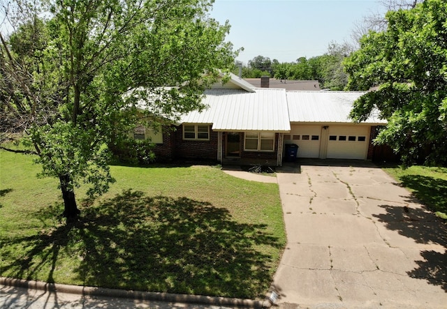 ranch-style house with a garage and a front lawn