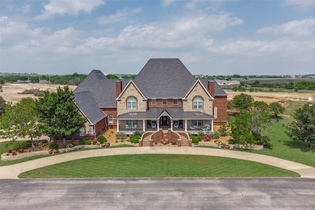 view of front of house featuring a front yard and a porch