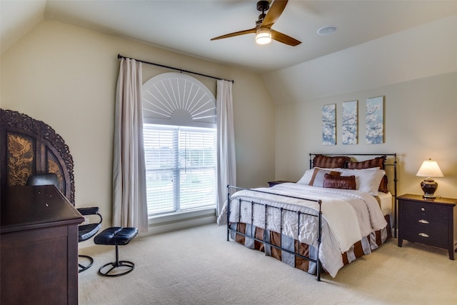 carpeted bedroom featuring lofted ceiling and ceiling fan