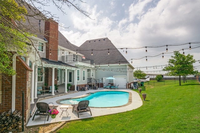 view of swimming pool featuring a patio area and a yard