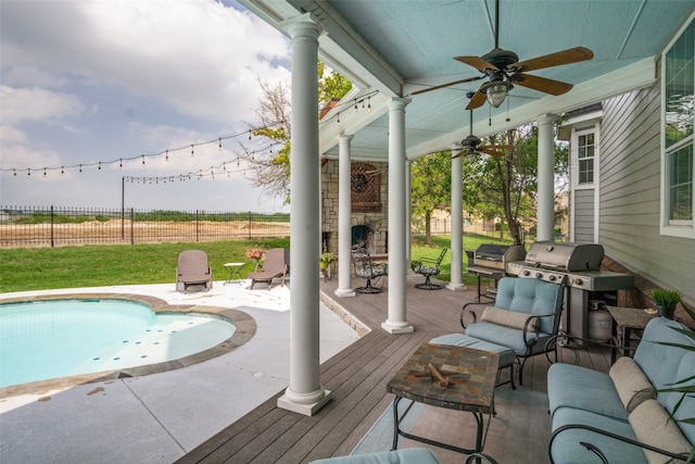 view of pool featuring ceiling fan and a wooden deck