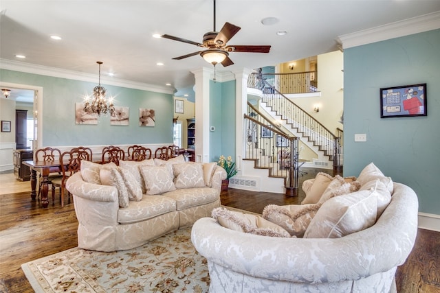 living room featuring ceiling fan with notable chandelier, crown molding, a wealth of natural light, and dark hardwood / wood-style floors