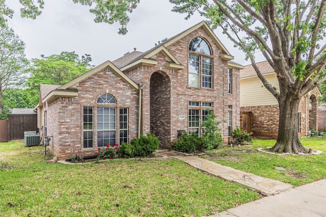 view of property with central AC and a front yard