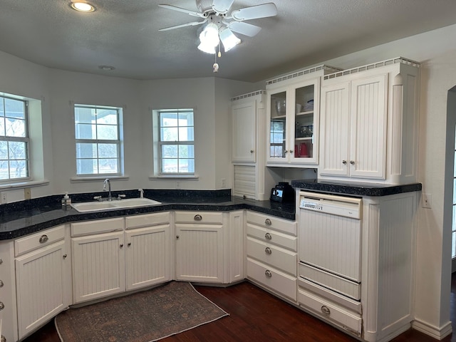 kitchen with sink, dark wood-type flooring, white cabinets, and white dishwasher