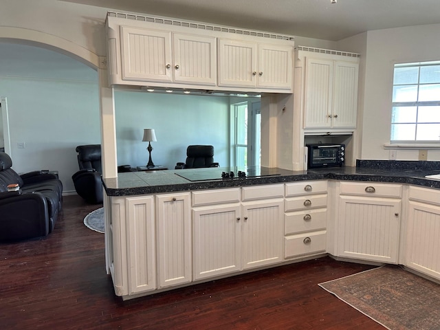 kitchen featuring white cabinetry, black electric cooktop, kitchen peninsula, and dark wood-type flooring