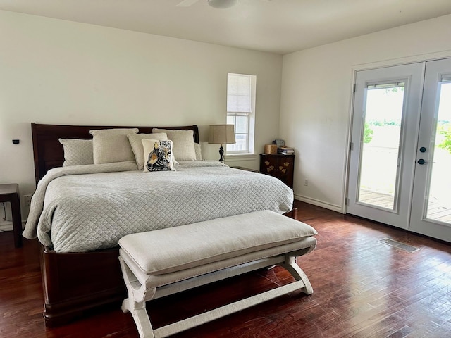 bedroom with multiple windows, dark wood-type flooring, access to exterior, and french doors