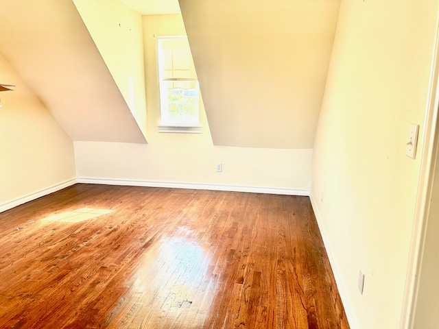 bonus room featuring vaulted ceiling and hardwood / wood-style flooring