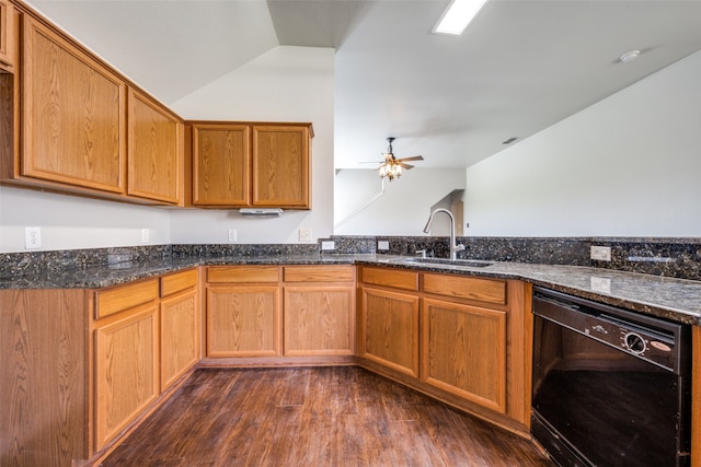 kitchen featuring dark stone countertops, dishwasher, dark wood-type flooring, ceiling fan, and sink