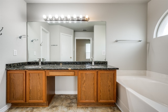 bathroom featuring tile patterned floors, a healthy amount of sunlight, double sink vanity, and a tub to relax in