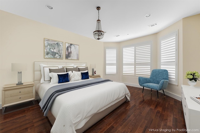 bedroom with visible vents, baseboards, wood finished floors, and recessed lighting