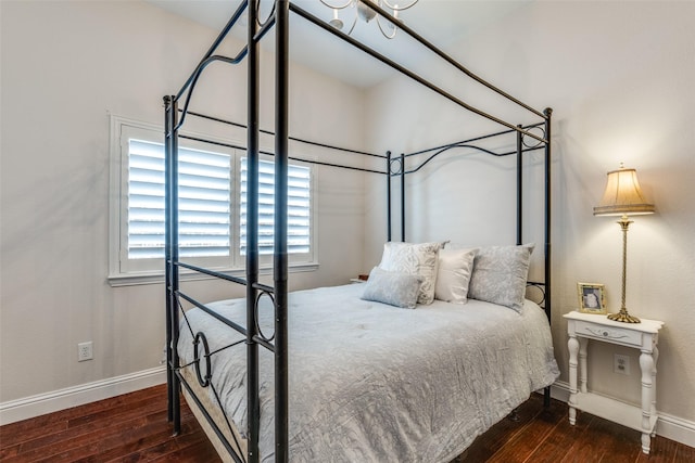 bedroom featuring baseboards and hardwood / wood-style floors