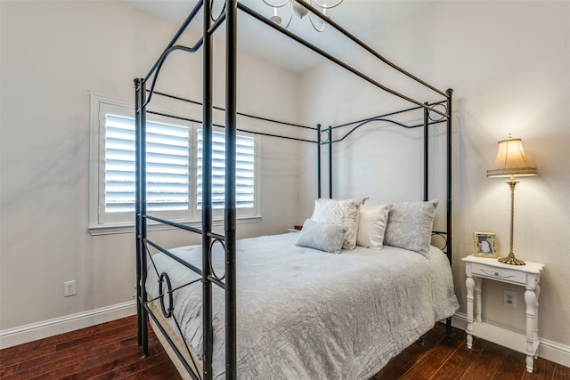 bedroom with dark hardwood / wood-style floors