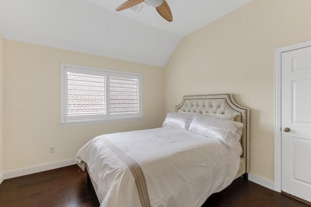 bedroom featuring a ceiling fan, lofted ceiling, dark wood-style flooring, and baseboards