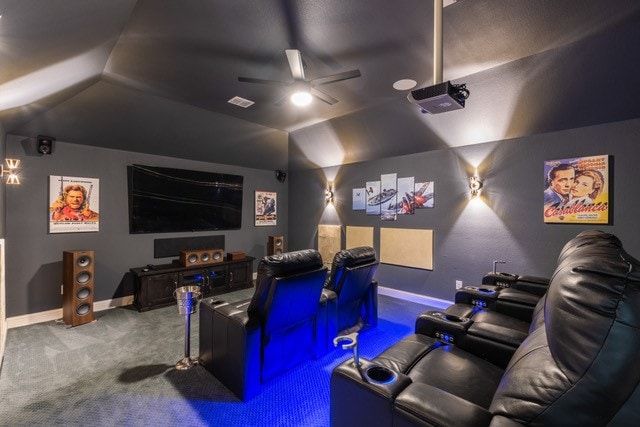 carpeted home theater featuring ceiling fan and lofted ceiling