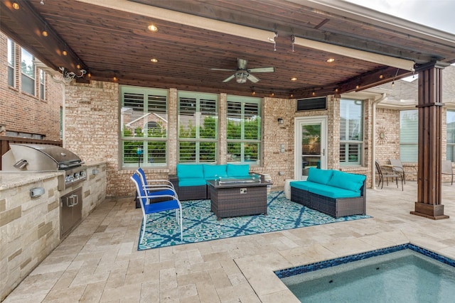 view of patio / terrace featuring exterior kitchen, outdoor lounge area, area for grilling, and a ceiling fan